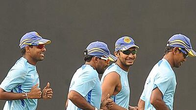 Kumar Sangakkara, second from right, the Sri Lanka captain, warms up with his teammates at R Premadasa Stadium in Colombo on Thursday. Sangakkara expects to shoulder his nation's expectations when they take on England in the quarter-finals today.
