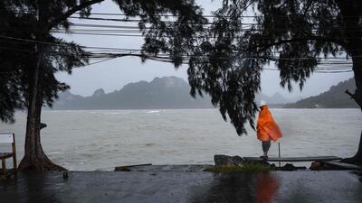 A man guards an empty pier after tour operators were forced to suspend boats to tourist islands due to tropical storm Pabuk, in the southern Thai province of Surat Thani. AFP