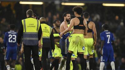 Cesc Fabregas shakes hands with Peterborough’s Lee Angol at the end of the match. Tony O’Brien / Reuters