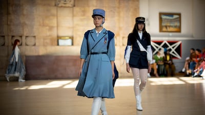 Looks were finished with military-style caps and medals at Bora Aksu. EPA