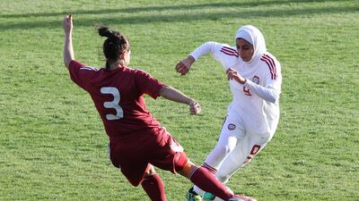 Shahad Budebs, right, is challenged by Latvia's Anna Proposina during their game at the 1st Aphrodite Cyprus Cup at Pegia Stadium in 2012. Sakis Savvides
