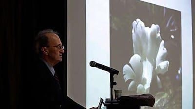 Robert Fontaine, an epidemiologist, shows a picture of the mushroom that he believes is responsible for hundreds of deaths.