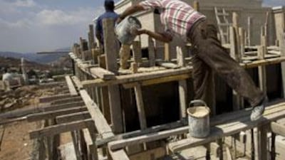 Palestinian labourers build a house in a Jewish settlement near Jerusalem.