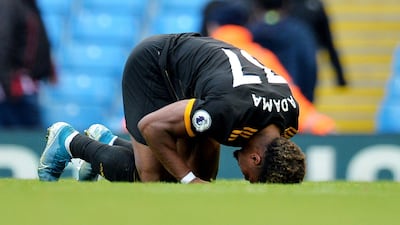 Traore kneels on the pitch after the final whistle. EPA