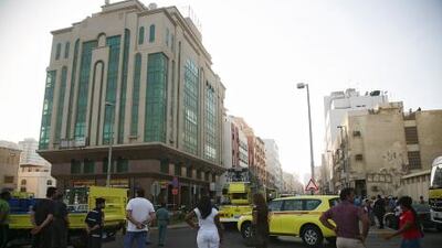 Emergency personnel surrounding the building off 15th Street in Abu Dhabi, where a fire broke out. The National
