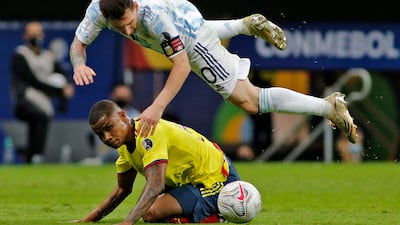 Lionel Messi takes a tumble after a challenge from Colombia's Wilmar Barrios.