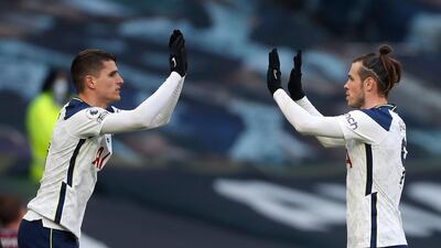 Tottenham Hotspur's Erik Lamela (left) greets Bale as he leaves the field. PA