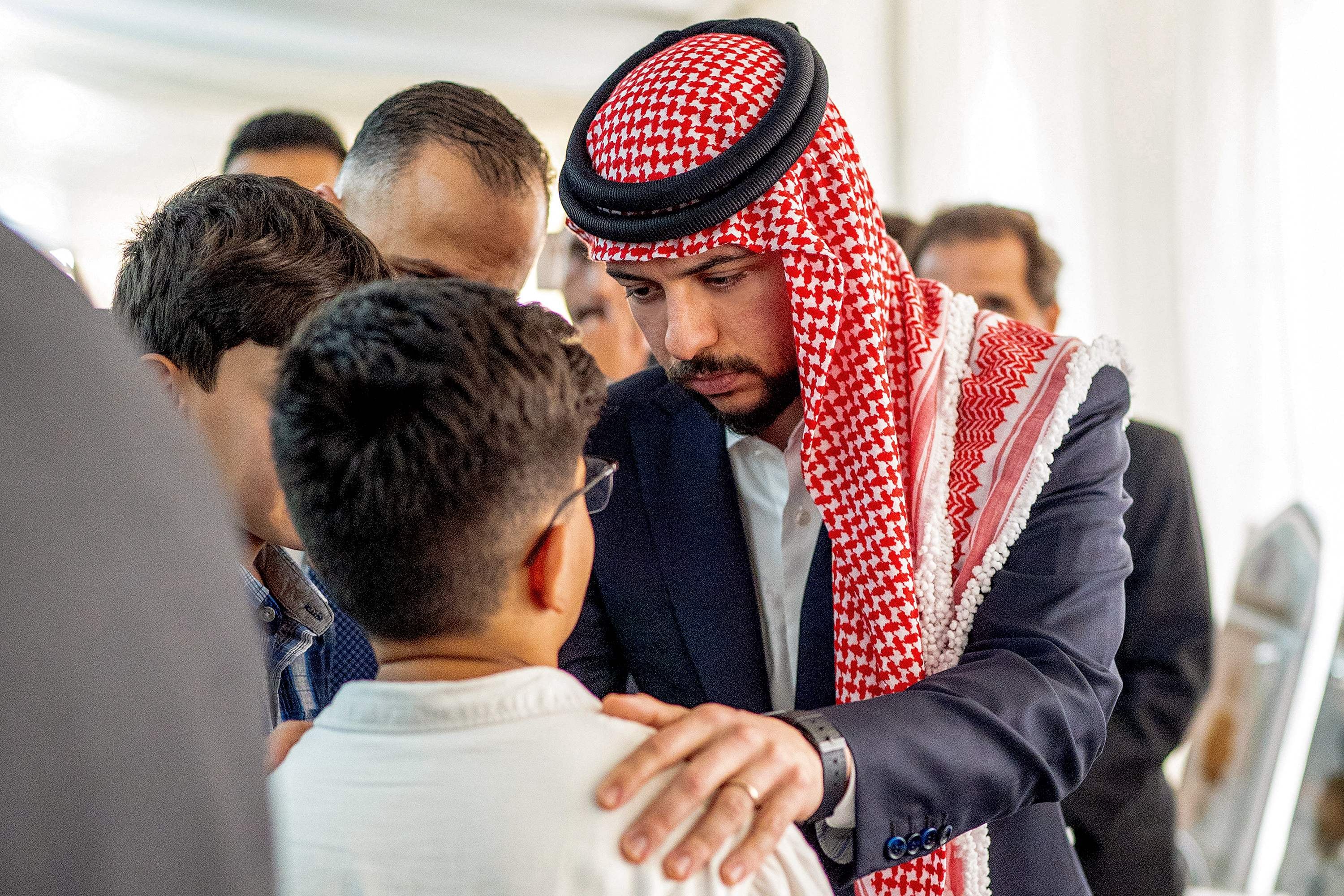 Crown Prince Hussein offers condolences at a memorial for the victims of the church shooting. AFP