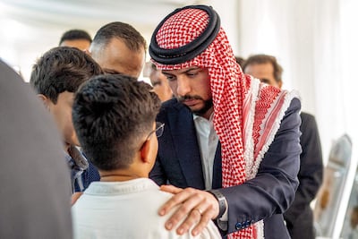 Crown Prince Hussein offers condolences at a memorial for the victims of the church shooting. AFP