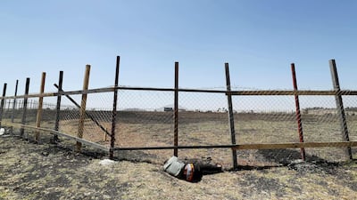 A mourner sleeps next to the fence of the crash site during a memorial service for the victims of the Ethiopian Airlines Flight ET302 plane crash near Bishoftu, Ethiopia. Reuters
