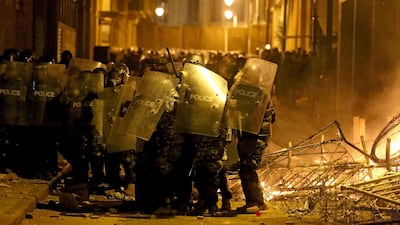 Riot police forces block a road leading to the parliament during clashes with anti-government protesters. AFP