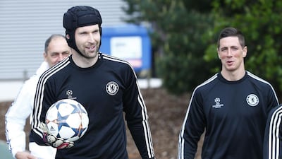 Chelsea goalkeeper Petr Cech, left, and Fernando Torres arrive for a soccer training session at Cobham in Surrey in south England April 29, 2014. Chelsea will play Atletico Madrid in their Uefa Champion's League semi-final second leg match on Wednesday. REUTERS/Eddie Keogh