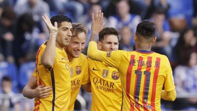 Luis Suarez, left, scored four and assisted three as Barcelona crushed Deportivo 8-0. Miguel Vidal / Reuters