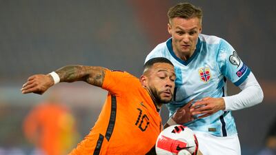 Norway's Stian Gregersen, right, and Netherlands' Memphis Depay collide as they compete for the ball. AP Photo