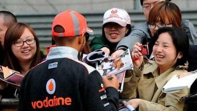Lewis Hamilton of Britain is mobbed by fans in the pit lane on Thursday ahead of Sunday's Chinese Grand Prix in Shanghai.