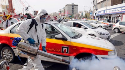 An Iranian firefighter disinfects a street in the capital Tehran, March 13. AFP