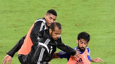 Saeed Al Kathiri (centre) is tackled by Hamdan Al Kamali (right) during a UAE national football team training session at Robina Stadium, Gold Coast, Australia. December 28 2014. Photo Courtesy: UAE FA