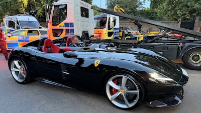 A police officer prepares to remove a Ferrari Monza. Photo: Metropolitan Police