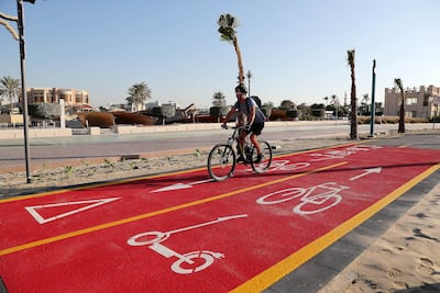 A cyclist makes use of a designated path on Jumeirah Beach Road. Pawan Singh / The National