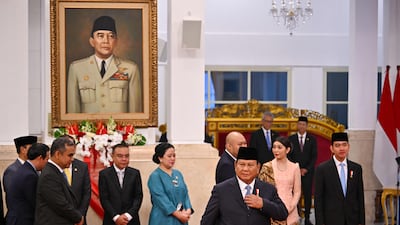 Indonesia's President Prabowo Subianto (3rd R) and Vice-President Gibran Rakabuming Raka (R) arrive for the swearing-in ceremony of the minister of the new cabinet at the Presidential Palace in Jakarta on October 21, 2024. Newly inaugurated Indonesian President Prabowo Subianto on October 21 swore in his new cabinet, which includes key members of his predecessor's team and suggests he will continue his main policies, analysts said. (Photo by BAY ISMOYO / AFP)