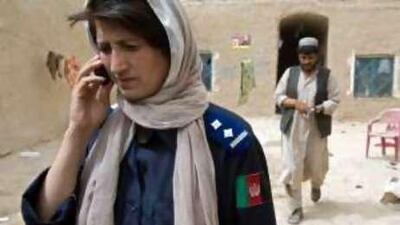 Malalai Kakar, the head of Kandahar's department for crimes against women, who was shot dead a week ago outside her home by Taliban gunmen, is pictured during a recent investigation into the alleged kidnapping of a girl.