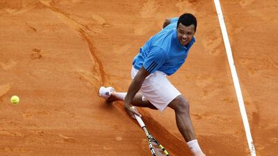 Tsonga returns the ball against Federer. The former world No 1 won 2-6, 7-6, 6-1. Sebastien Nogier / EPA