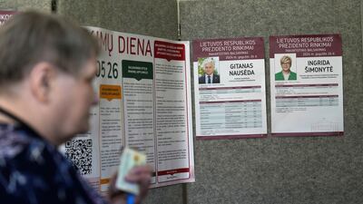 A woman waits during the second round of the presidential election in Pasvalys, Lithuania. Reuters