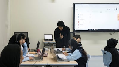 A teacher and students attend class, at Al Asayel Primary School. Mohamed Al Hammadi / Crown Prince Court - Abu Dhabi