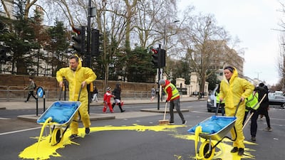 The group used wheelbarrows to pour the paint