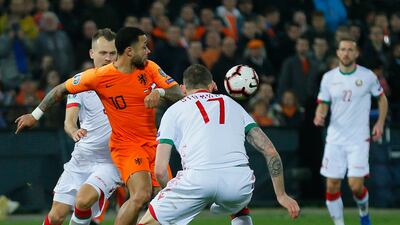 Depay and Belarus' Mikhail Sivakov challenge for the ball. AP Photo