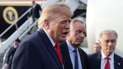 WEST PALM BEACH, FLORIDA - OCTOBER 23: U. S. President Donald Trump (L) speaks to members of the press as Secretary of Health and Human Services Robert F. Kennedy Jr. (2nd L) and Administrator for the Centers for Medicare and Medicaid Services Dr. Mehmet Oz (R) look on after they landed at Donald J. Trump International Airport on October 23, 2026 in West Palm Beach, Florida. President Trump traveled to Florida Gulf Coast University in Fort Myers, Florida to rally for local Republican candidates ahead of next week's midterm elections. Alex Wong / Getty Images / AFP (Photo by ALEX WONG / GETTY IMAGES NORTH AMERICA / Getty Images via AFP)