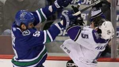 Vancouver Canucks' Shane O'Brien, left, checks the Los Angeles Kings' Peter Harrold during their clash on Friday.