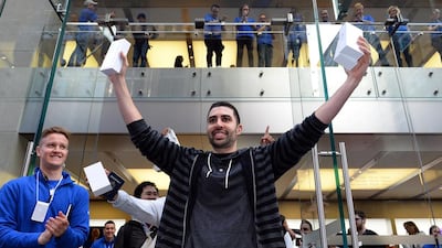 A reader wonders why the world is abuzz with so much excitement over the new iPhone. Above, the first buyer of an iPhone 6, David Rahimi, from California, displays his new purchases in Sydney. Saeed Khan / AFP