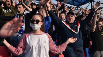 Fans of FC Dinamo-Minsk show support for their team. AFP