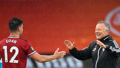 Sheffield United's John Egan is congratulated by manager Chris Wilder. AFP