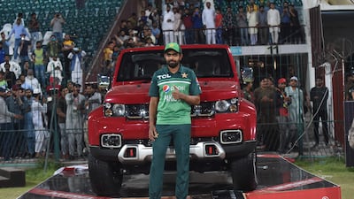 Babar Azam poses with car he won for being the player of the series. AFP