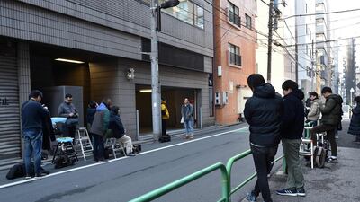 Members of the media wait outside an entrance to the offices of the Japanese lawyers for former Nissan chief Carlos Ghosn in Tokyo. AFP