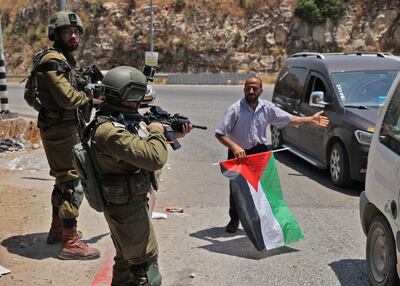 Israeli soldiers stop a funeral procession at a checkpoint leading out of the Palestinian village of Nilin, west of Ramallah, in the occupied West Bank. AFP