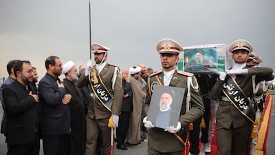 Iranian honour guards carry president Ebrahim Raisi's coffin during a funeral procession at Mehrabad Airport in Tehran. AFP