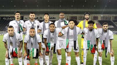 Players of Qatar's Al Sadd SC football club, wearing Palestinian-style embroidered scarves in solidarity with the Palestinian people, pose for a group photo ahead of the Emir Cup semi-final match in Qatar's capital Doha. AFP