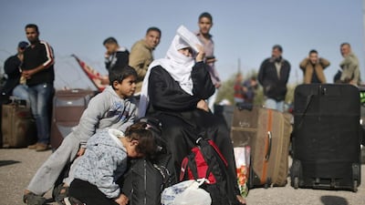 A Palestinian girl rests as others hoping to cross into Egypt wait at the Rafah crossing between Egypt and the southern Gaza Strip on March 29. Mohammed Salem / Reuters