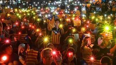 People hold Catalan pro-independence "Estelada" flags and light up their mobile phones during a Hong Kong-Catalonia solidarity assembly in Central district in Hong Kong, China. AFP