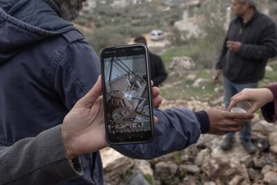 One family watches a video showing the destruction of their home inside the Jenin refugee camp. Patricia Martinez / The National