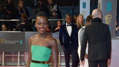 Lupita Nyong’o poses for photographers on the red carpet at the EE British Academy Film Awards held at the Royal Opera House on Sunday Feb. 16, 2014, in London. Jon Furniss / Invision / AP