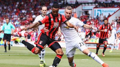 Luke Shaw of Manchester United challenges Callum Wilson of AFC Bournemouth during the Premier League match between AFC Bournemouth and Manchester United at Vitality Stadium on August 14, 2016 in Bournemouth, England. Michael Steele / Getty Images