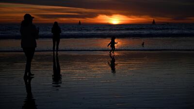 People visit the beach a day before renewed restrictions due to a surge of Covid-19 cases in Los Angeles, California, US. Reuters