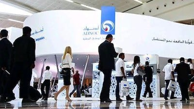 Visitors stream past the Adnoc stand at Adipec. Lee Hoagland / The National