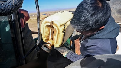 A farmer pours diesel into his tractor in Ancocala, Bolivia. Global energy prices have remained volatile and elevated amid continuing geopolitical conflicts. Reuters
