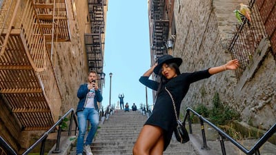 A woman does a 'Joker' dance on the staircase in the Bronx, made famous by the movie 'Joker' on Wednesday, October 23, 2019 in New York. AFP