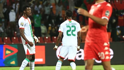 Burkina Faso's forward Dango Ouattara (L) celebrates after scoring his team's first goal during the Africa Cup of Nations quarter-final football match between Burklina Faso and Tunisia. AFP.